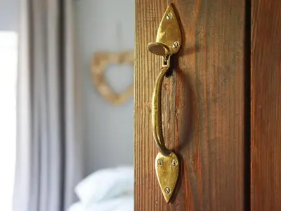 a gold door handle on a wooden door at Cae Lleci in Dolgellau