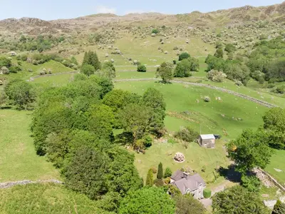 an overhead view of a field with trees and a house at Cae Lleci in Dolgellau