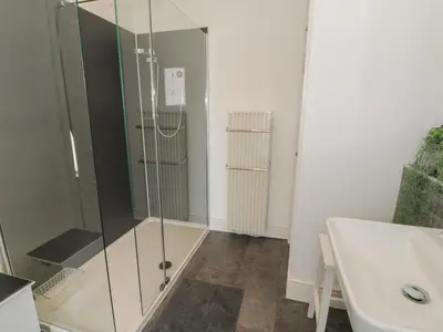 a bathroom with a glass shower and a sink at Minffordd in Blaenau-Ffestiniog