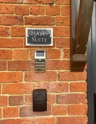 a brick wall with a sign that reads haves suite at Hayes Suite in Oswestry