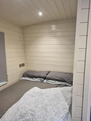 a small bedroom with two beds in it at Glamping Hut - Sleeps 2 hot tub & parking in Welshpool