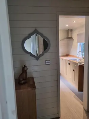 a kitchen with a mirror on the wall at Glamping Hut - Sleeps 2 hot tub & parking in Welshpool