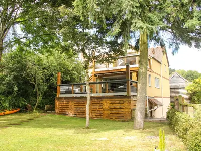 a house with a wrap around deck in the yard at Sunnyside in Leominster