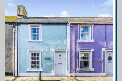 a row of houses painted in different colors at 13 Tabernacle Street - Aberaeron in Aberaeron