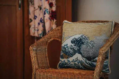 a pillow on a chair with a wave on it at 13 Tabernacle Street - Aberaeron in Aberaeron