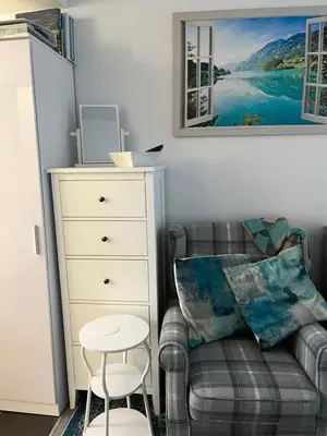 a living room with a couch and a dresser at Flat 2 Frank Lewis House in Hay-on-Wye