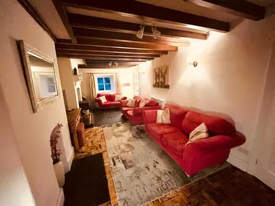 a living room with red couches in a room at Avondale in Llangollen