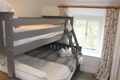 two bunk beds in a room with a window at Avondale in Llangollen