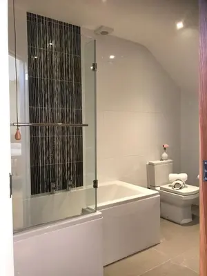 a white bathroom with a tub and a toilet at 2 Bed Rural cottage between the mountains and Sea in West Wales in Lampeter