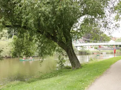 two people in a boat on a river with a tree at 42 Albury Place in Shrewsbury