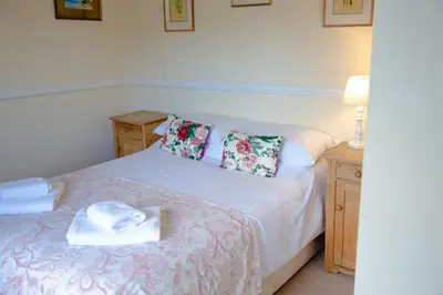 a bedroom with a bed with towels on it at The Powis Arms in North Lydbury