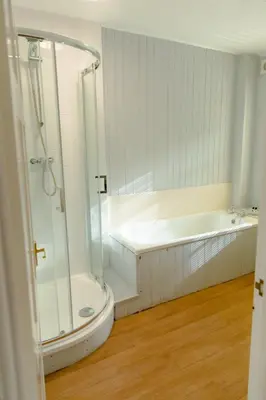 a bathroom with a shower and a bath tub at The Powis Arms in North Lydbury