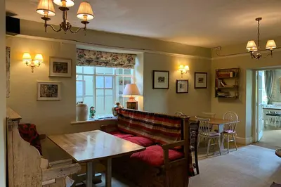 a living room with a couch and a table at The Powis Arms in North Lydbury