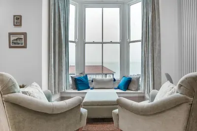 a living room with two chairs and a large window at 1 Bed in Aberystwyth oc-bow285 in Aberystwyth