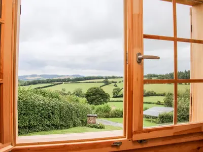 a window with a view of a green field at Callow Fold in Craven Arms
