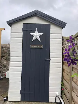 a black and white shed with a star on it at bwthyn y porthmyn in Llandovery