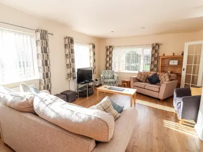 a living room with a couch and a tv at Awel Y Berwyn in Oswestry