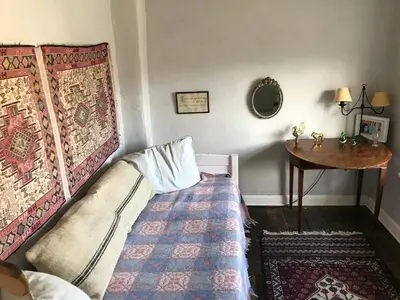 a small bedroom with a bed and a table at Half Moon House top flat in Hay-on-Wye