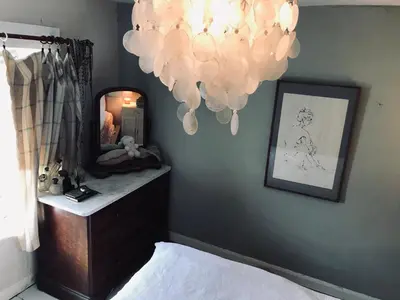 a bedroom with a mirror and a bed and a dresser at Half Moon House top flat in Hay-on-Wye