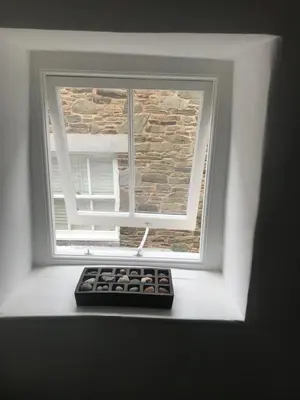 a window with a remote control in front of it at Half Moon House top flat in Hay-on-Wye