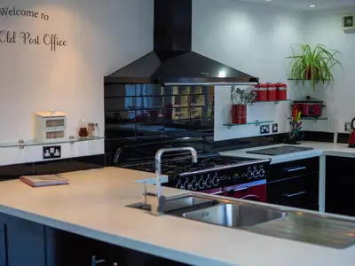 a kitchen with a sink and a stove top oven at The Old Post Office in Llandrindod Wells