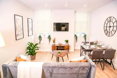 a living room with a couch and a table at Shrewsbury apartments by BEVOLVE - Free Parking in Shrewsbury