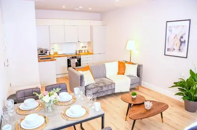 a living room with a couch and a table at Shrewsbury apartments by BEVOLVE - Free Parking in Shrewsbury
