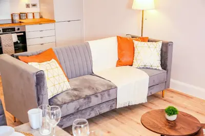 a living room with a couch and a table at Shrewsbury apartments by BEVOLVE - Free Parking in Shrewsbury