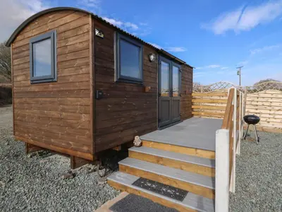 a wooden tiny house with a wooden deck at Claerwen in Llandrindod Wells