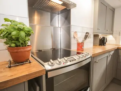 a kitchen with a stainless steel stove top oven at Cuddfan in Llangollen