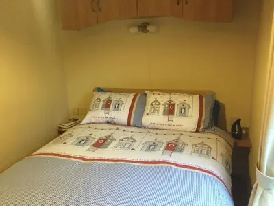 a small bed with two pillows on top of it at D19 in Aberystwyth