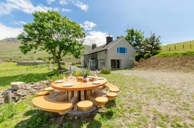 a table and chairs in front of a house at 6 Bed in Barmouth oc-bow245 in Fairbourne