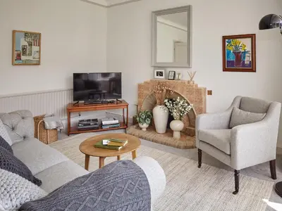 a living room with a couch and a tv at Green Acres in Llangollen