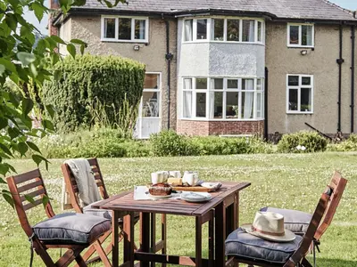 a wooden table in the yard of a house at Green Acres in Llangollen
