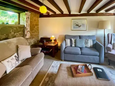 a living room with a couch and a table at Jinney Ring in Leintwardine