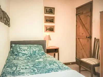 a bedroom with a bed and a table and a chair at Jinney Ring in Leintwardine