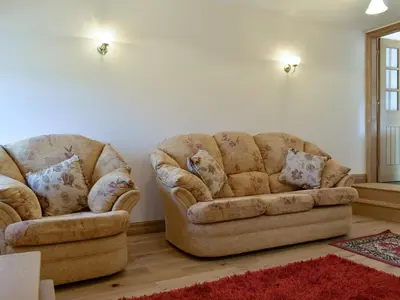 two chairs and a couch in a living room at Stabal Rhoswen in Ffestiniog
