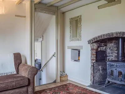 a living room with a couch and a fireplace at Pentre Cwm Bach in Llansilin