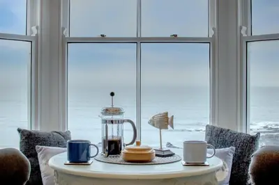 a table with two mugs and a blender on it in front of a window at 2 Bed in Aberystwyth oc-bow200 in Aberystwyth