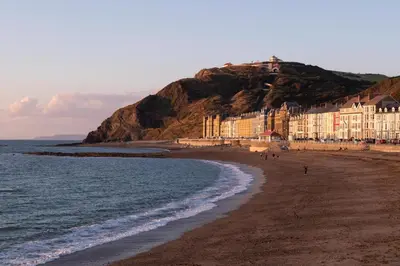 a view of a beach with buildings and the ocean at 2 Bed in Aberystwyth oc-bow200 in Aberystwyth