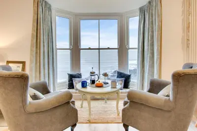 a living room with a table and chairs and a large window at 2 Bed in Aberystwyth oc-bow200 in Aberystwyth