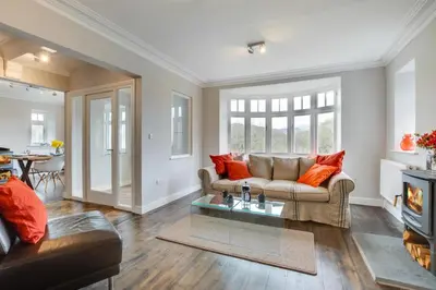 a living room with a couch and a table at 4 Bed in Barmouth oc-bow259 in Barmouth
