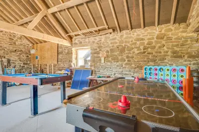 a room with a ping pong table and chairs at 4 Bed in Welshpool oc-wab267 in Welshpool