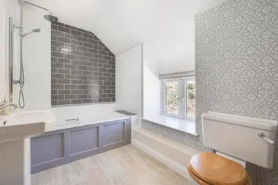 a bathroom with a sink and a toilet and a window at 4 Bed in Welshpool oc-wab267 in Welshpool