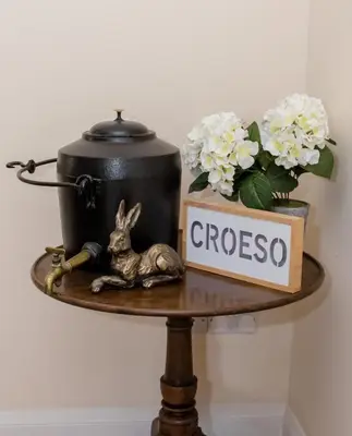 a table with a rabbit and a pot and flowers at 4 Bed in Welshpool oc-wab267 in Welshpool