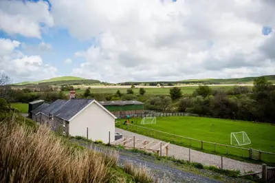a field with a building and a soccer field at 4 Bed in Welshpool oc-wab267 in Welshpool