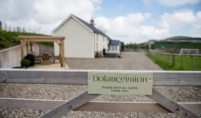 a sign on a gate in front of a house at 4 Bed in Welshpool oc-wab267 in Welshpool