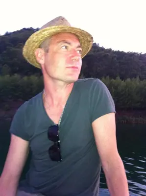 a man wearing a straw hat and a tie at The Pavement Palace in Hay-on-Wye