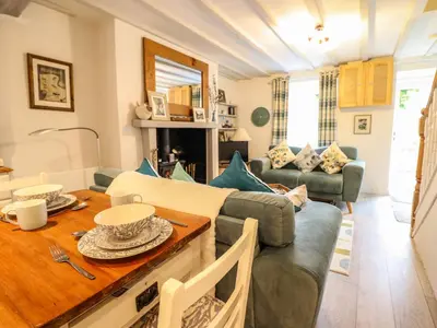 a living room with a couch and a table at Cartrefle in Bala