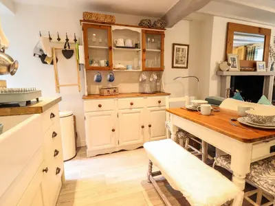 a kitchen with a table and a dining room at Cartrefle in Bala